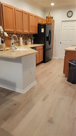 a kitchen with stainless steel appliances a sink a stove and a refrigerator