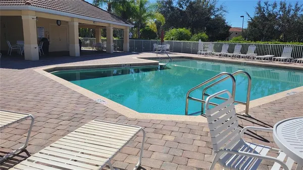a view of balcony with wooden floor outdoor seating and yard in back