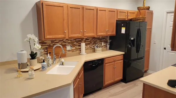 a kitchen with a sink and refrigerator