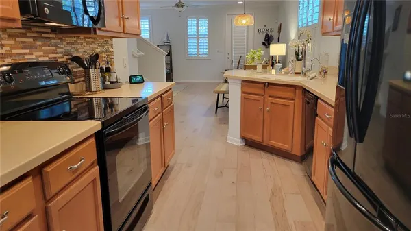 a kitchen with stainless steel appliances a sink stove and cabinets