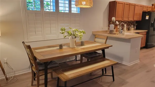 a dining room with furniture and a potted plant