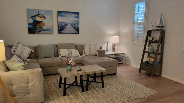 a living room with furniture and a wooden floor