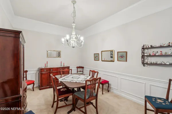a view of a dining room with furniture and chandelier