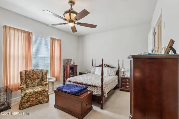 a bedroom with bed and window