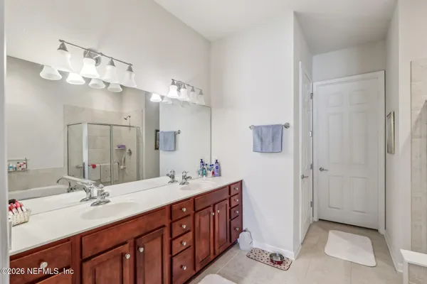 a bathroom with a double vanity sink mirror and double