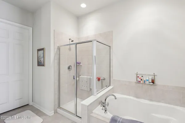 a bathroom with a bathtub and a shower