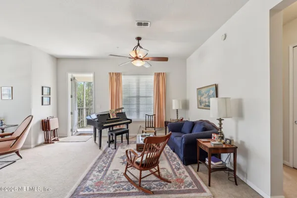 a living room with furniture and large windows