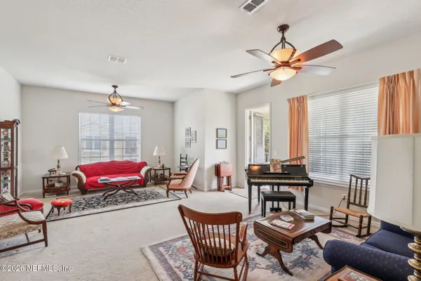 a living room with furniture and a large window