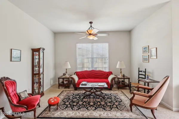 a living room with furniture a rug and a window