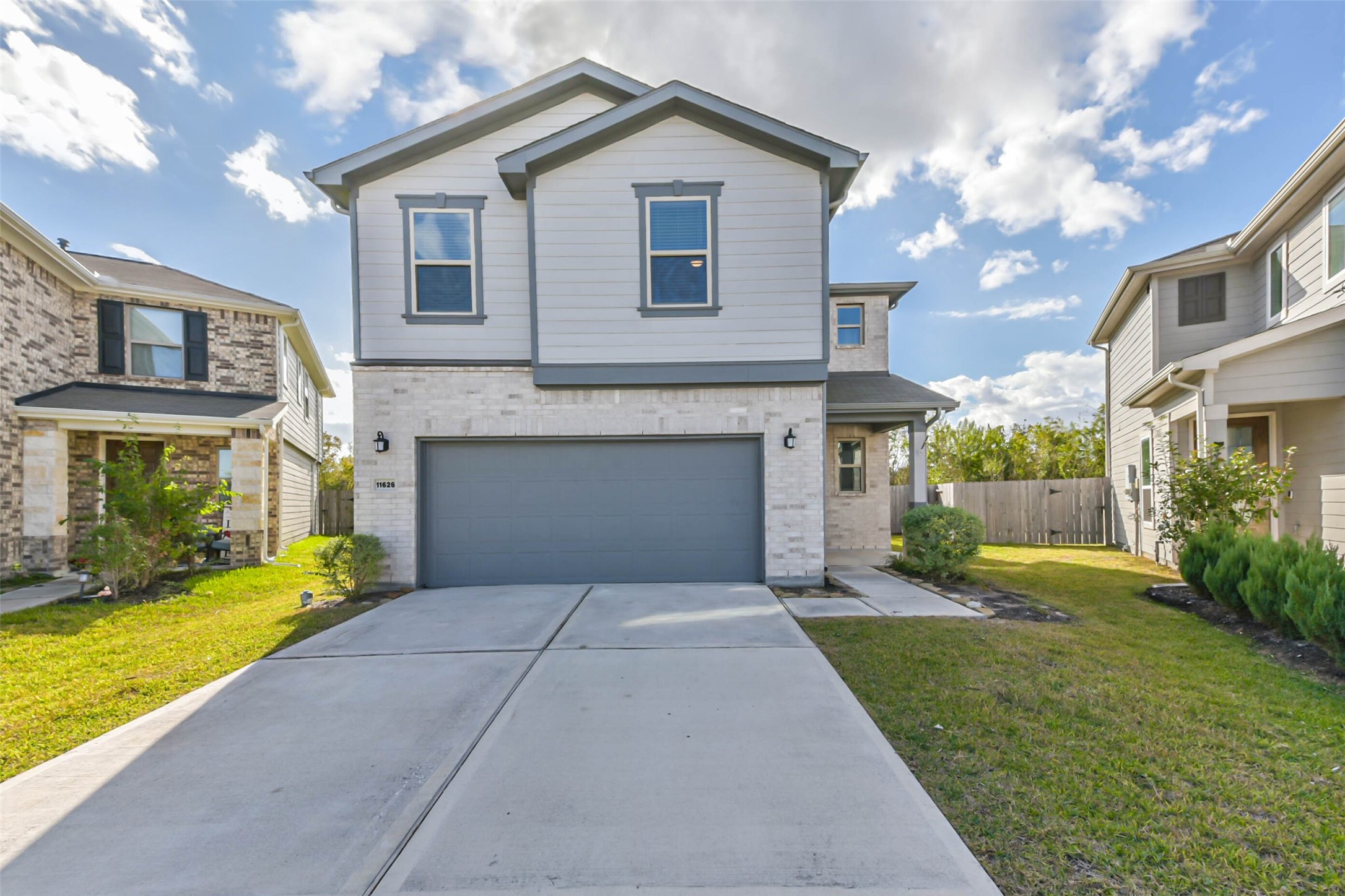 11626 Moonstruck Lane Houston, TX 77048 - Photo 1 of 35 a front view of a house with a yard and garage