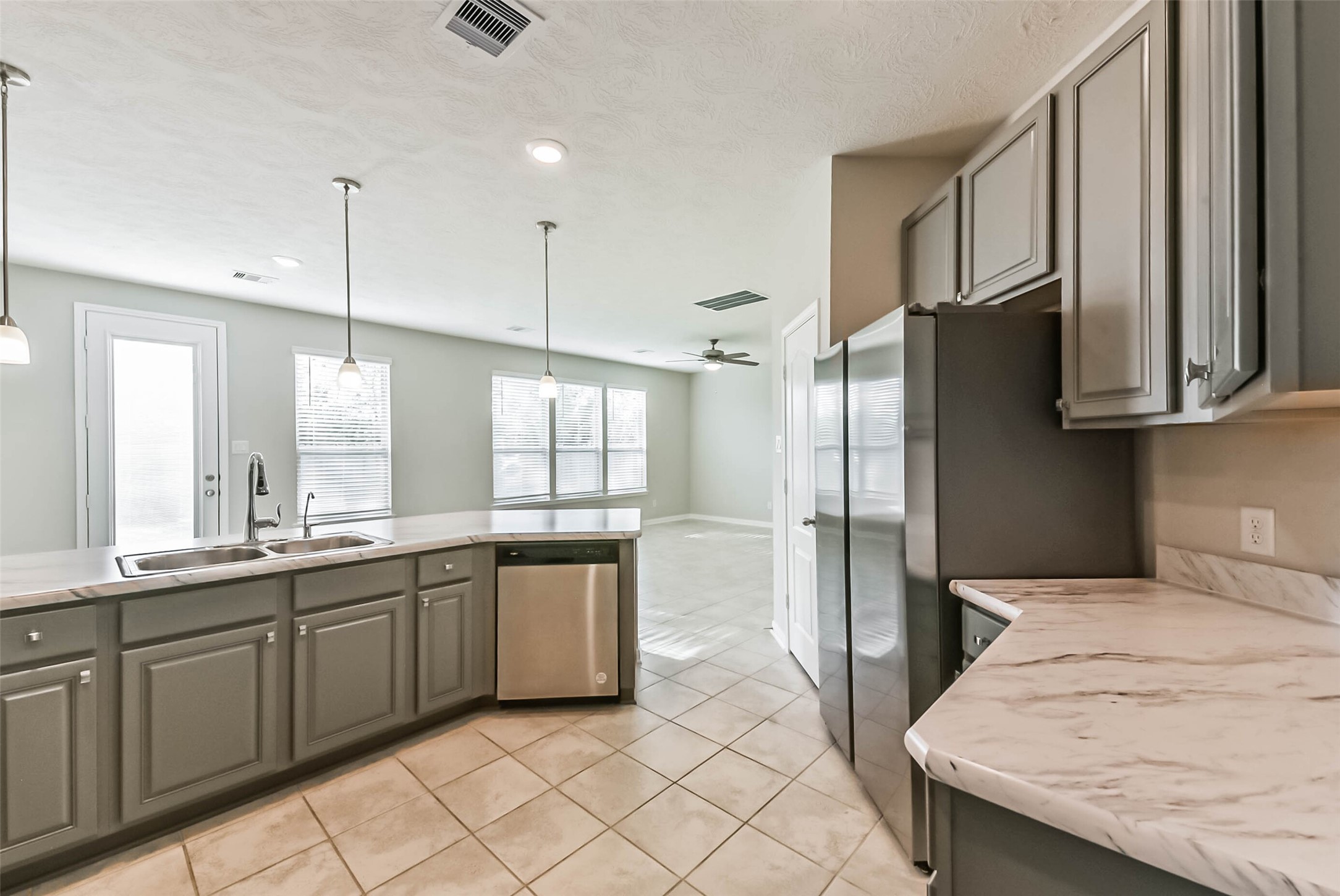 11626 Moonstruck Lane Houston, TX 77048 - Photo 11 of 35 a kitchen with stainless steel appliances granite countertop a sink and a refrigerator