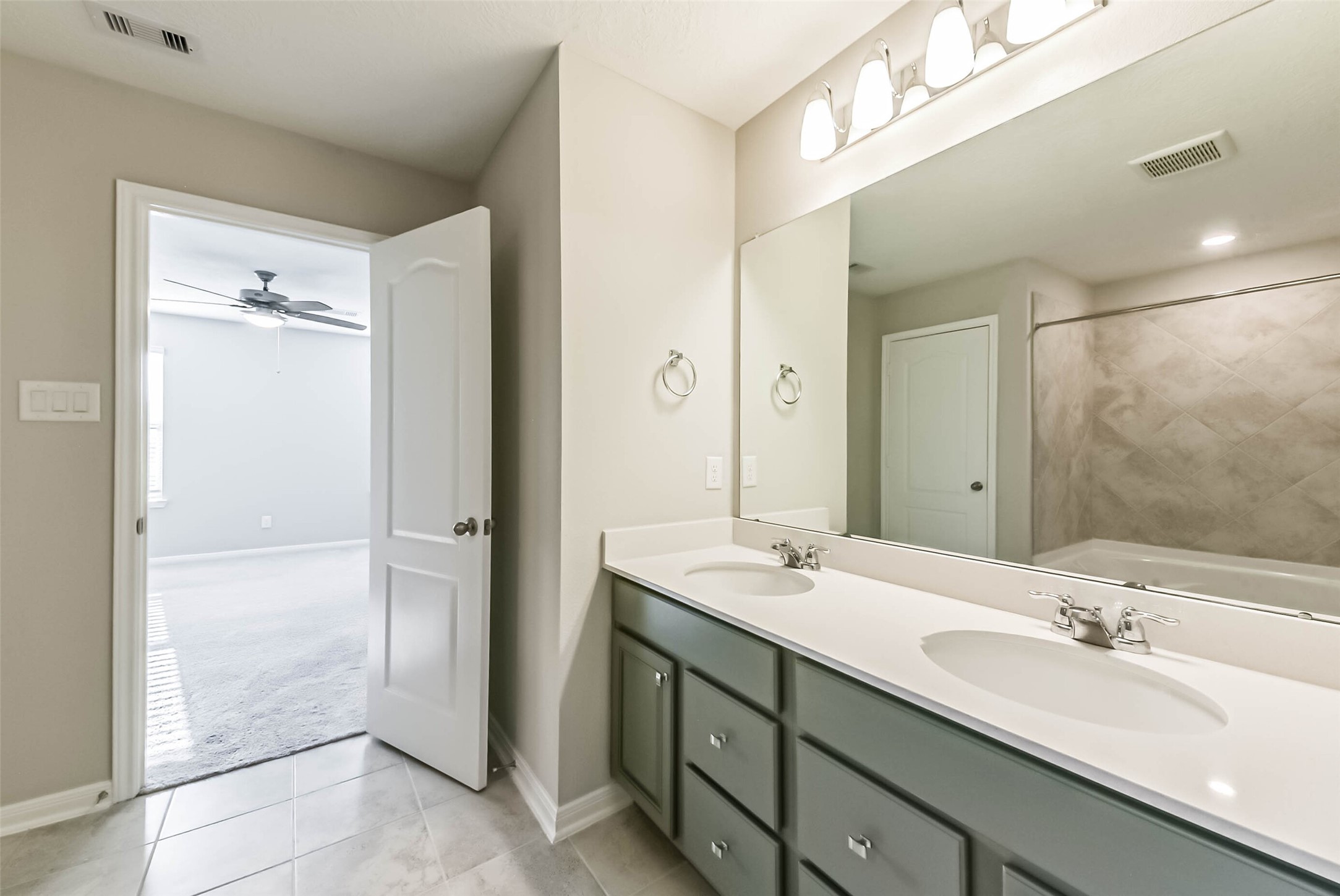 11626 Moonstruck Lane Houston, TX 77048 - Photo 23 of 35 a bathroom with a double vanity sink mirror and shower