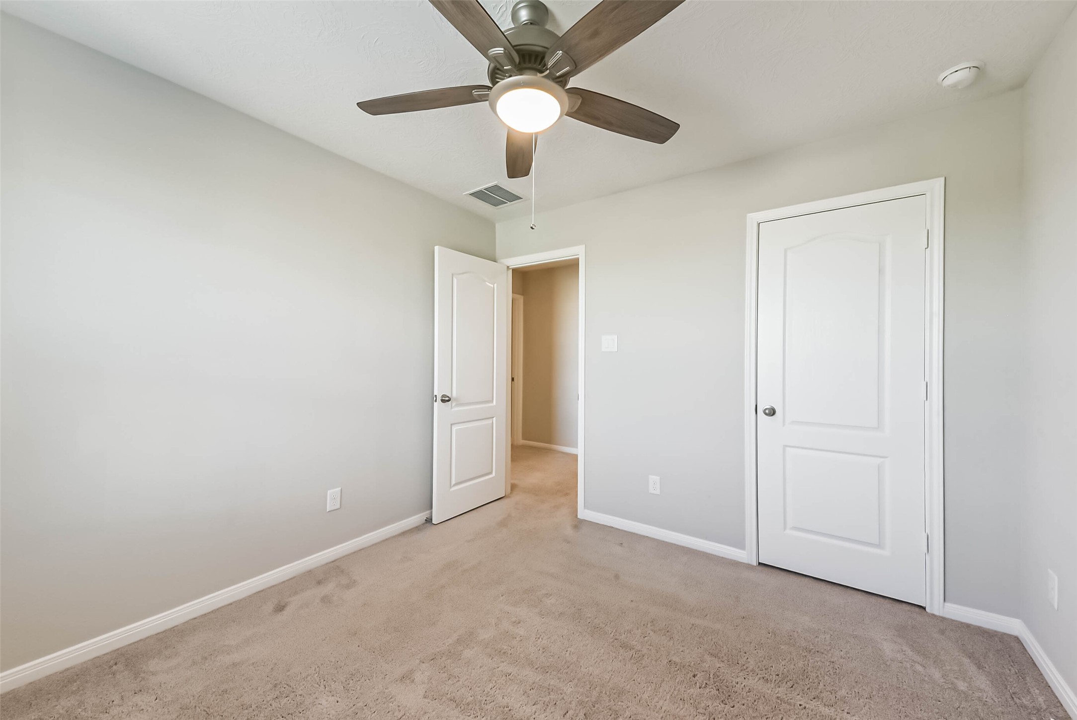 11626 Moonstruck Lane Houston, TX 77048 - Photo 27 of 35 an empty room with closet and a chandelier fan