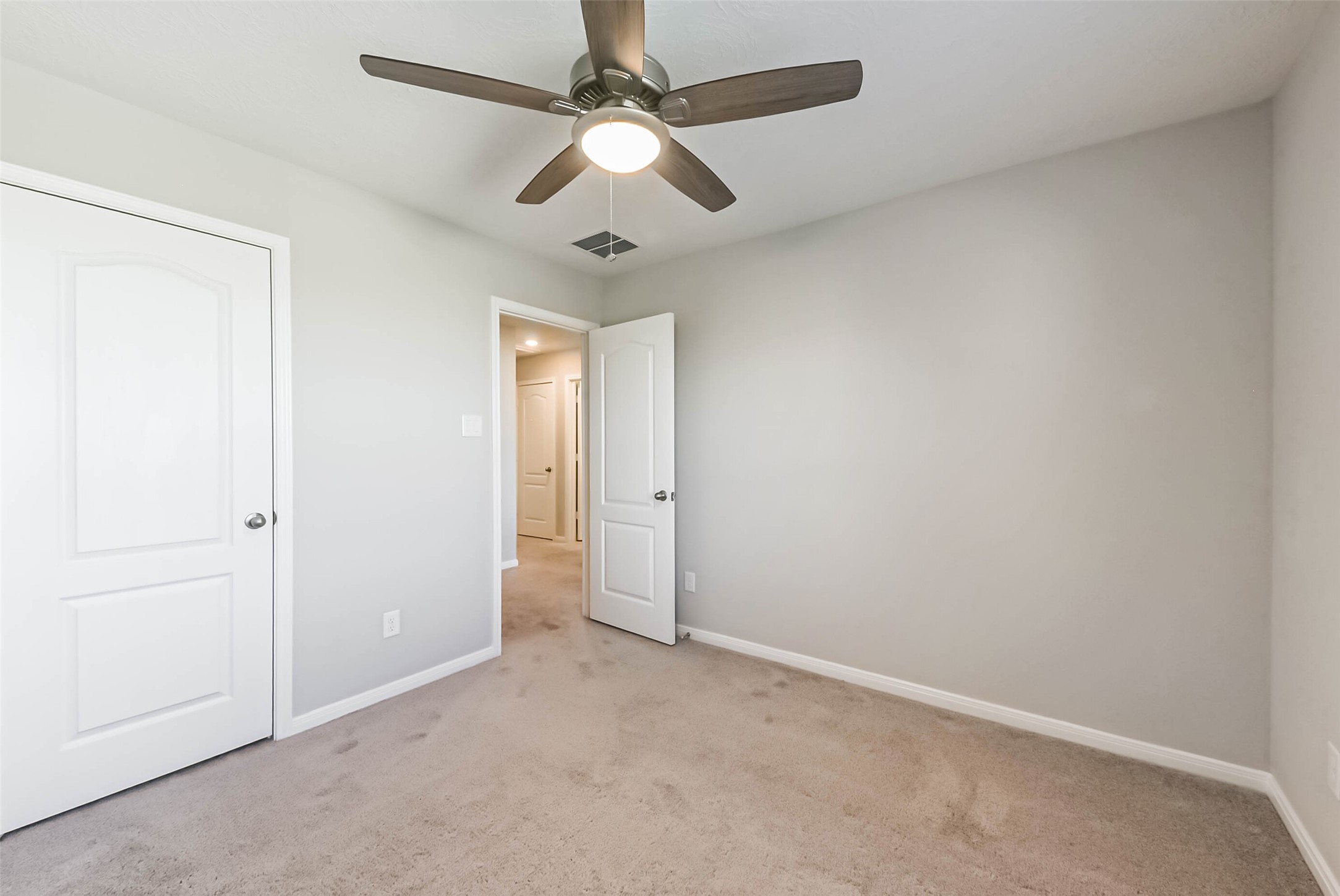 11626 Moonstruck Lane Houston, TX 77048 - Photo 29 of 35 an empty room with a ceiling fan and a window