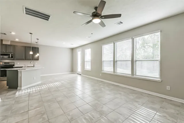 a view of a kitchen with a sink and a refrigerator