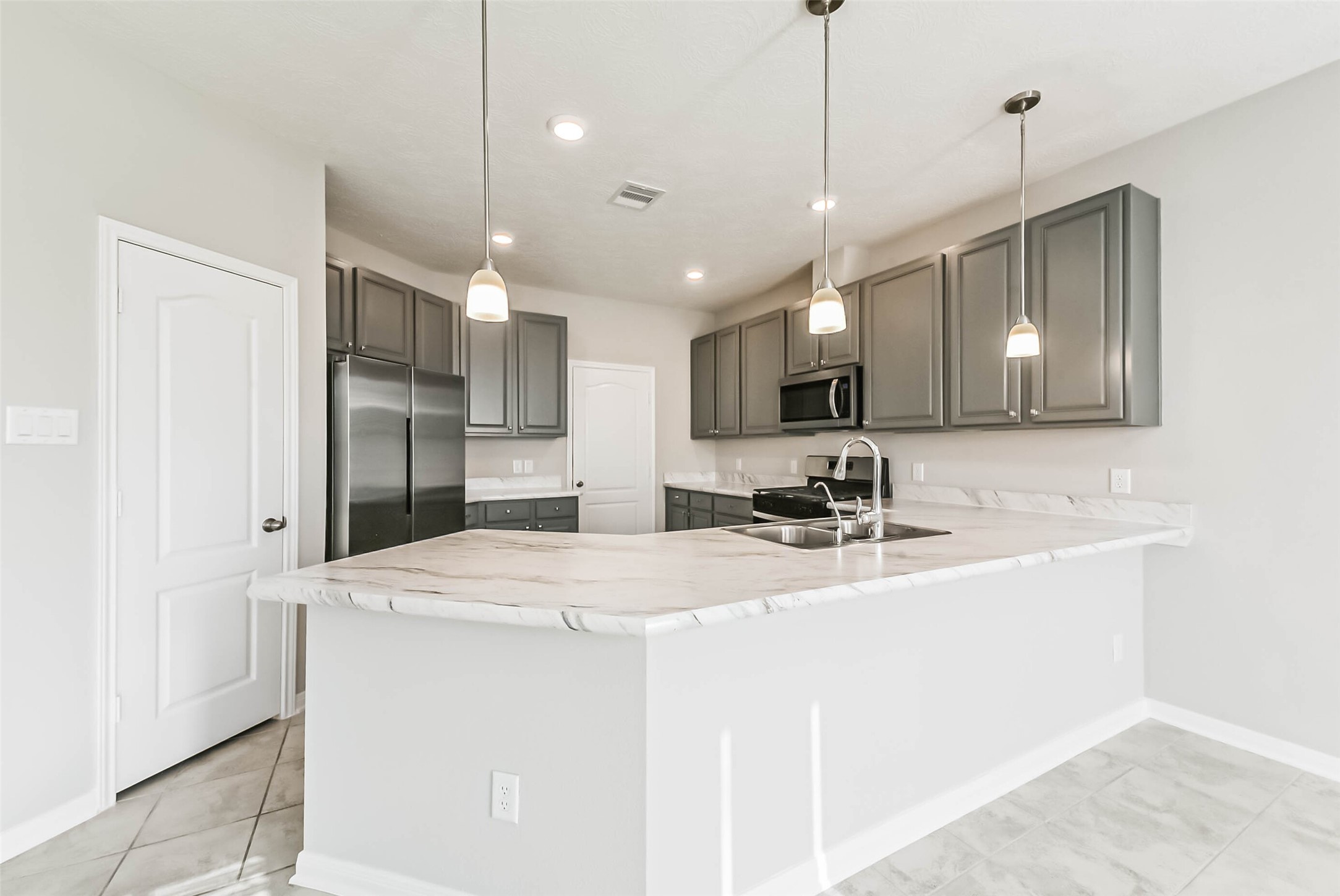 11626 Moonstruck Lane Houston, TX 77048 - Photo 8 of 35 a view of a kitchen with a sink and refrigerator