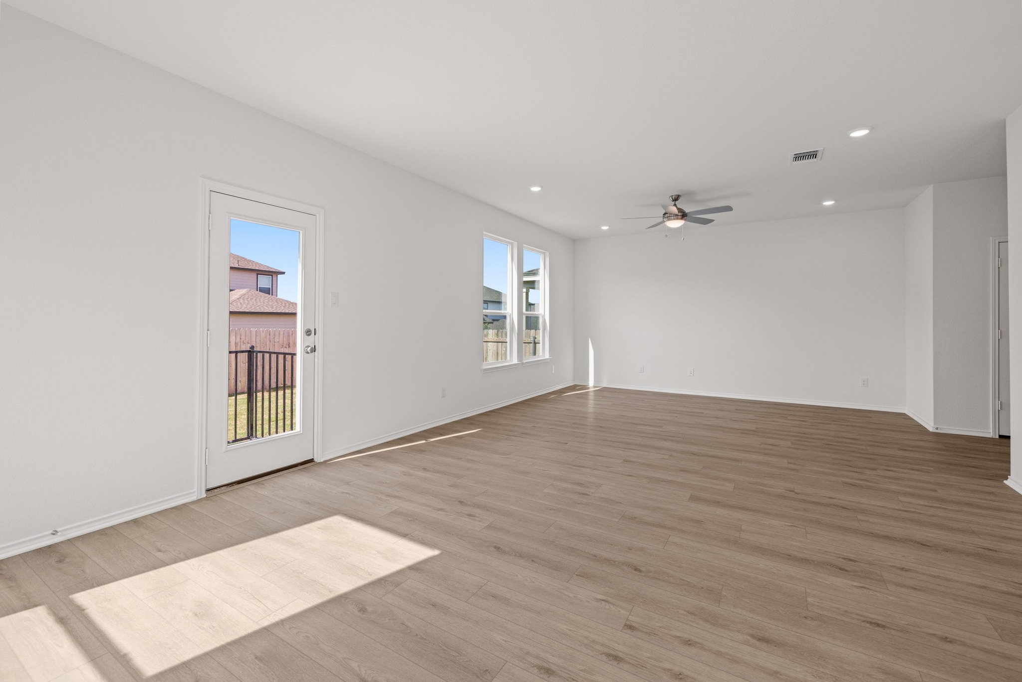 161 Lucky Texan Road Jarrell, TX 76537 - Photo 7 of 32 a view of an empty room with window and wooden floor