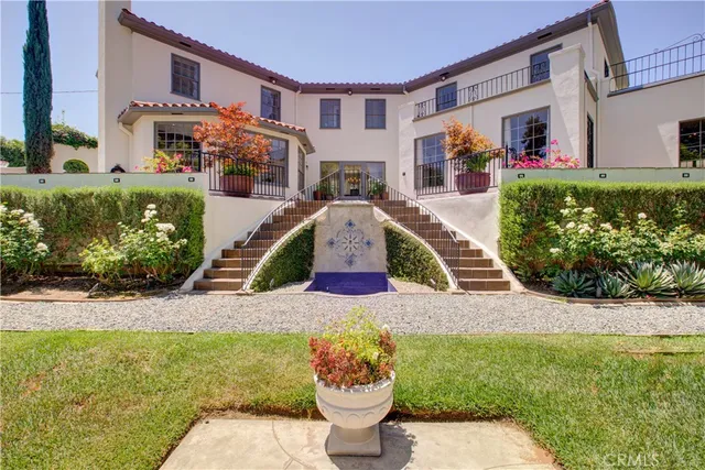 a front view of a house with a garden