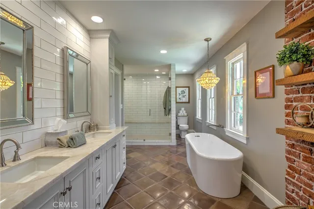 a spacious bathroom with a bathtub shower sink double vanity and a mirror