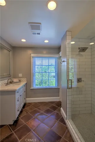 a spacious bathroom with a granite countertop sink a toilet and shower