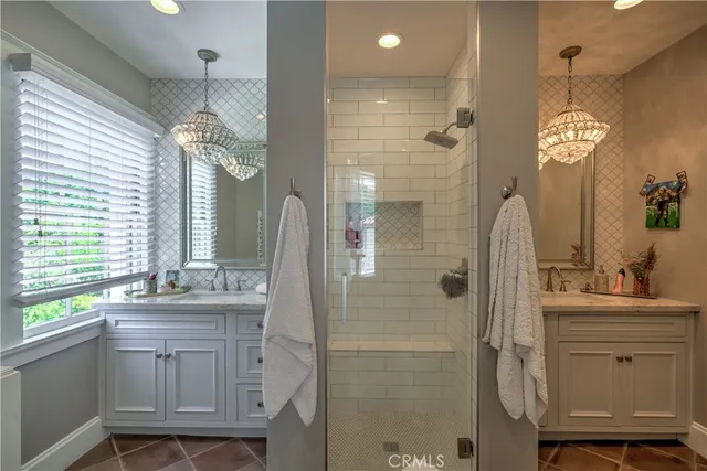 a bathroom with a double vanity sink mirror and shower