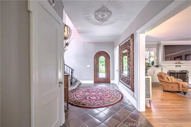 a view of a hallway with dining room and wooden floor