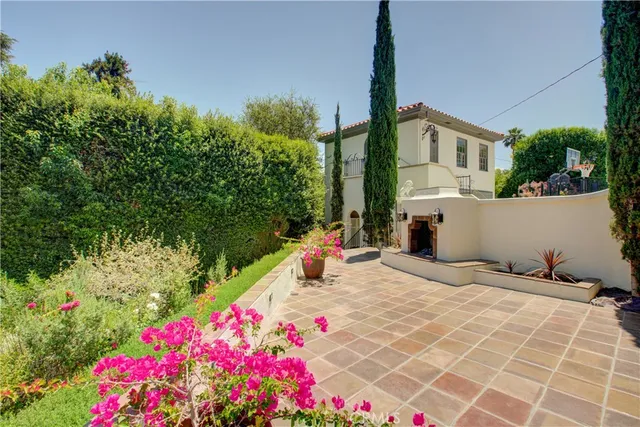 a view of a house with potted plants