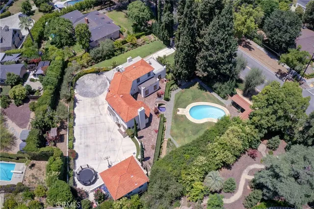 an aerial view of a house with a swimming pool yard and outdoor seating