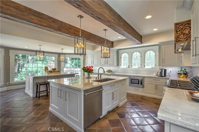 a kitchen with sink stove and cabinets