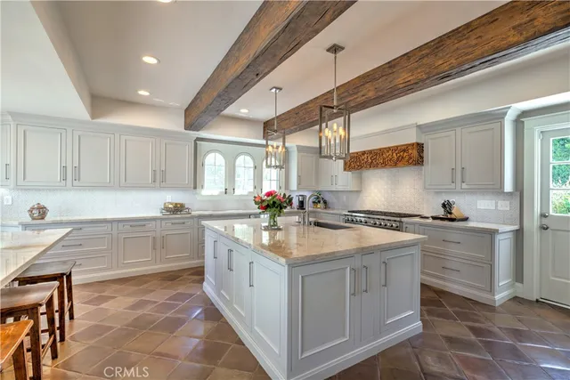 a kitchen with granite countertop a sink stove and cabinets