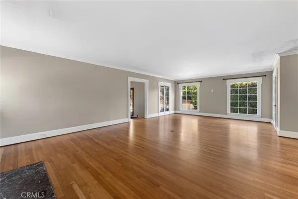 a view of wooden floor and windows in a room