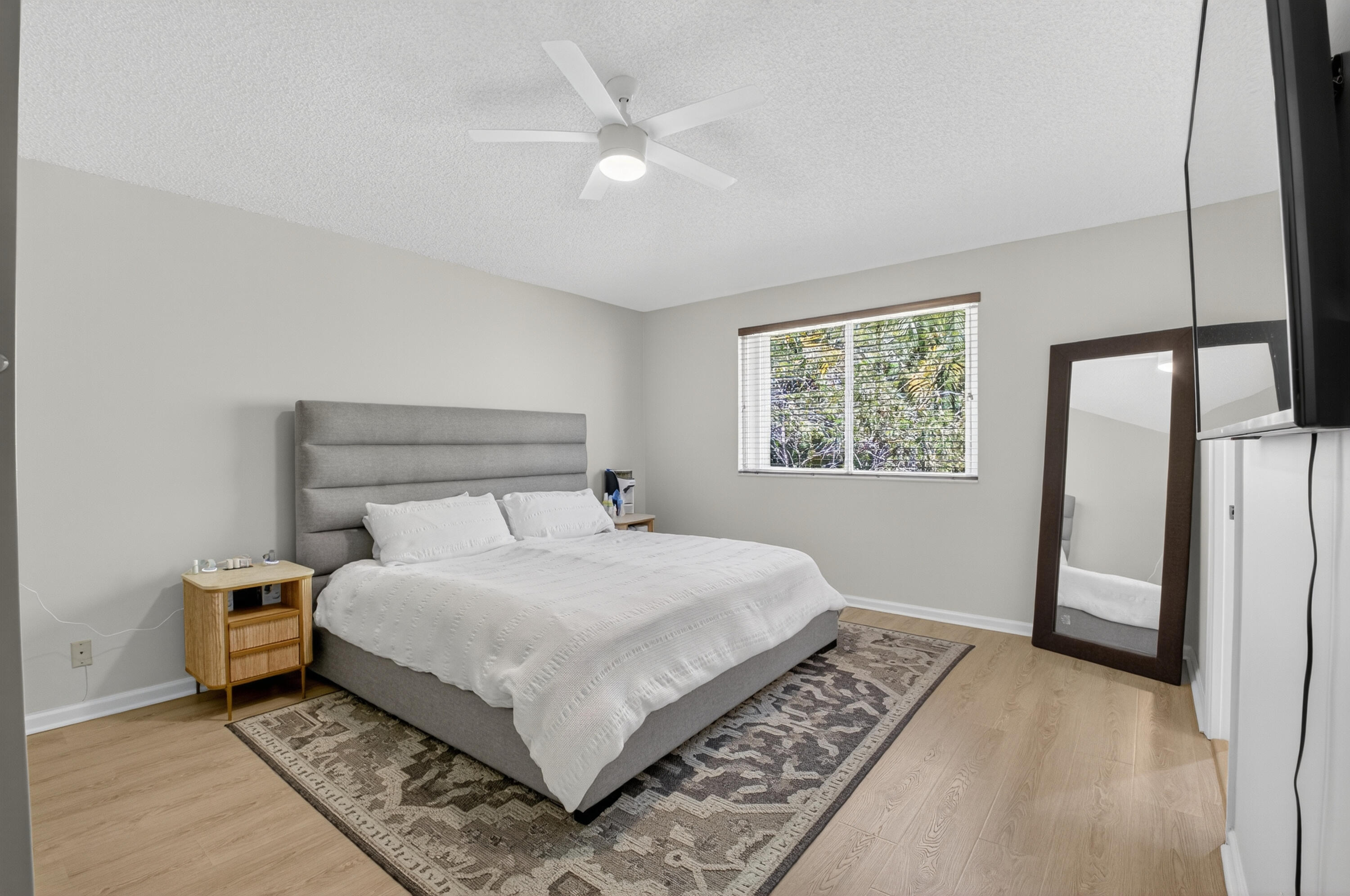 21048 Vía Eden Boca Raton, FL 33433 - Photo 15 of 53 a bedroom with a large bed lamps and a window