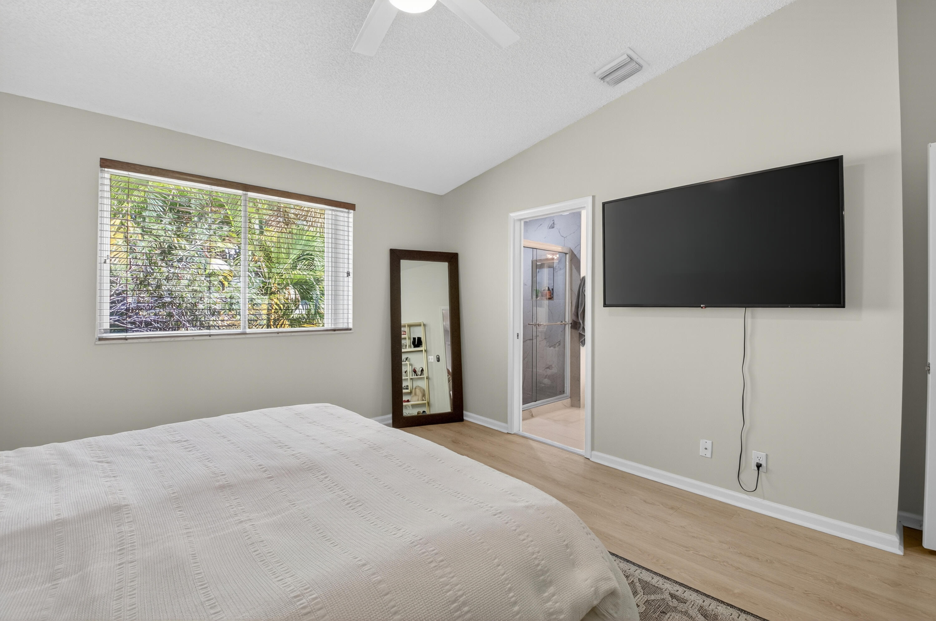 21048 Vía Eden Boca Raton, FL 33433 - Photo 16 of 53 a bedroom with a bed and a flat screen tv