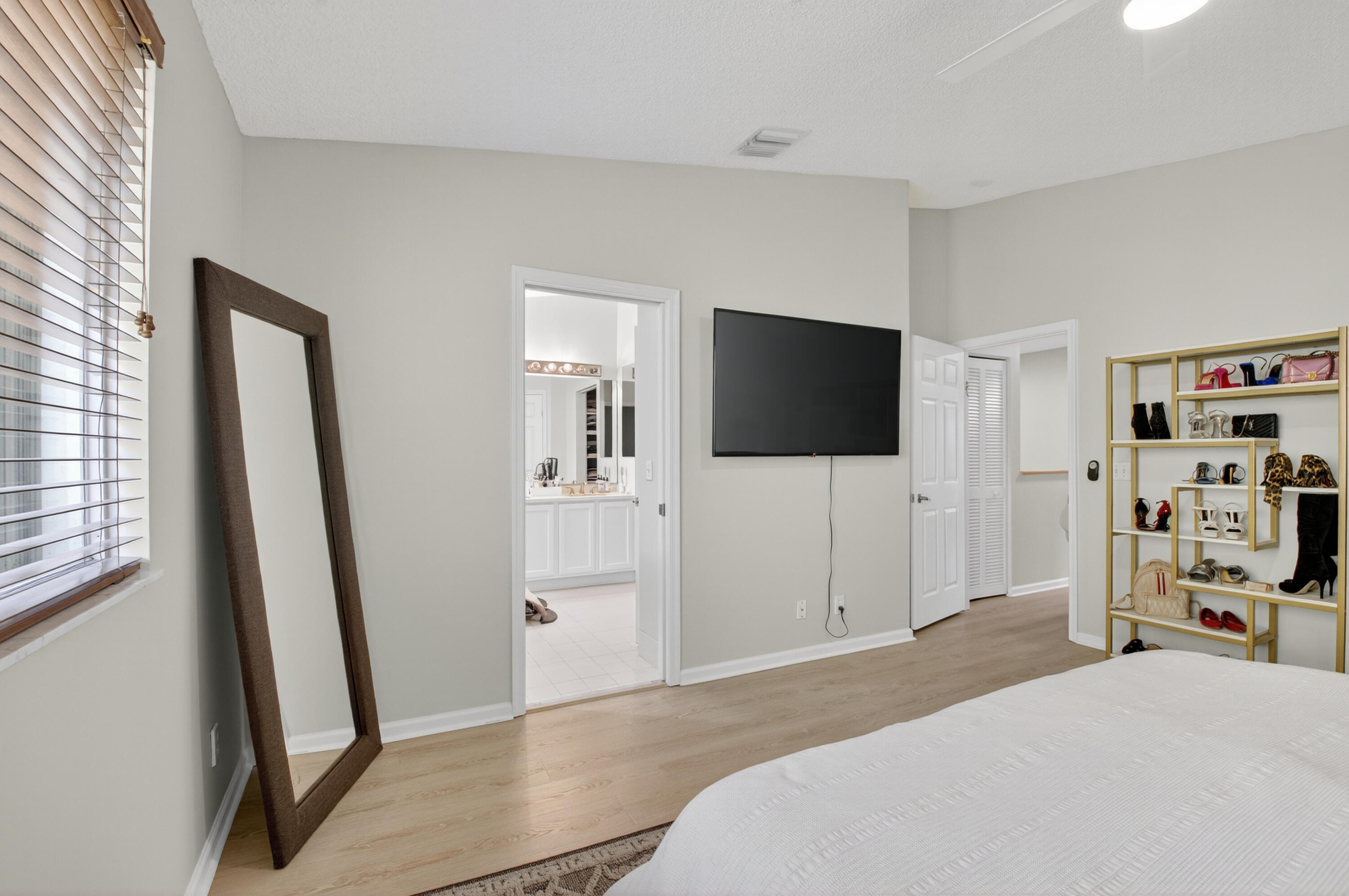 21048 Vía Eden Boca Raton, FL 33433 - Photo 17 of 53 a bedroom with a bed and a flat screen tv