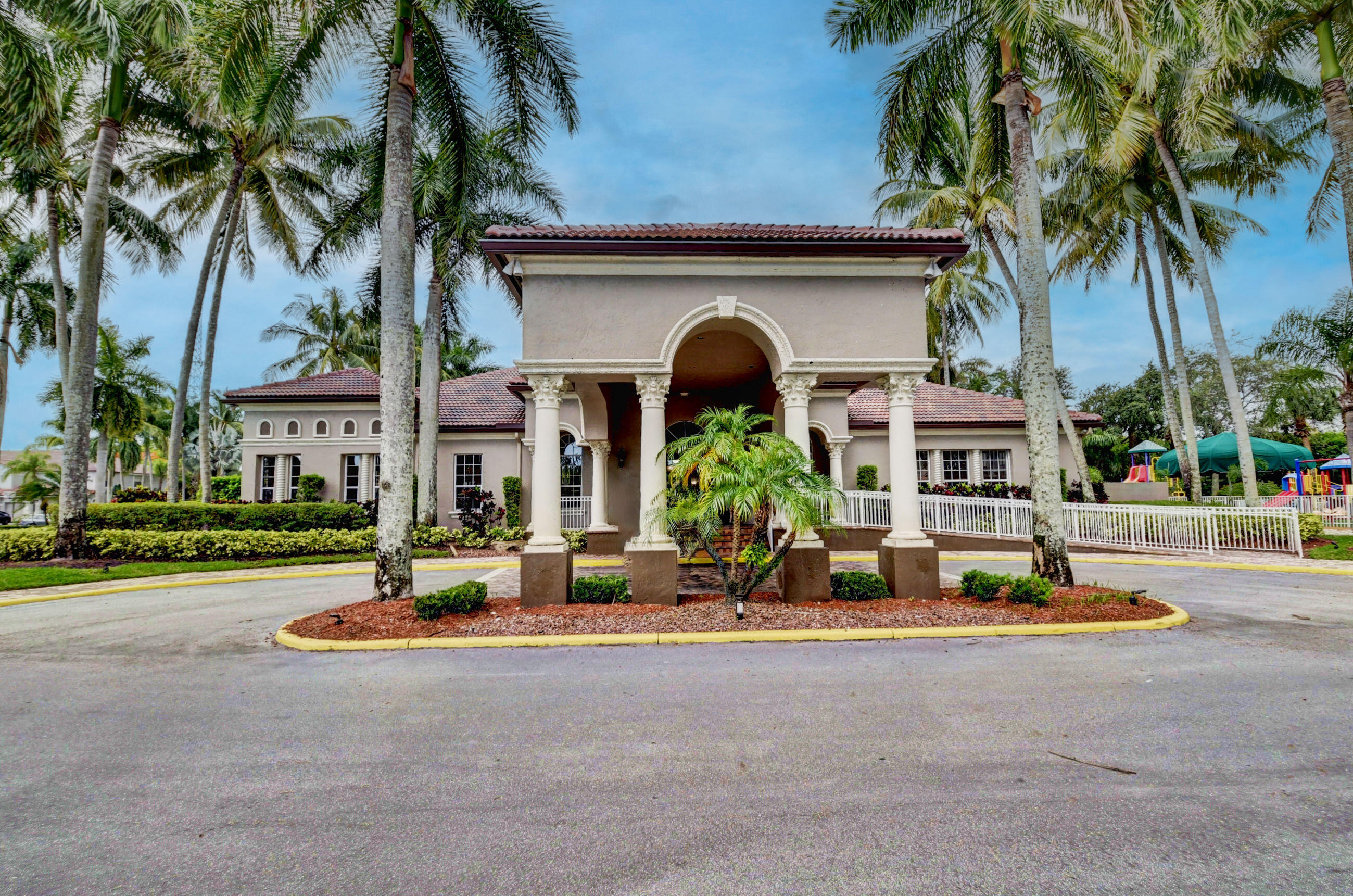 21048 Vía Eden Boca Raton, FL 33433 - Photo 29 of 53 a front view of a house with garden and trees