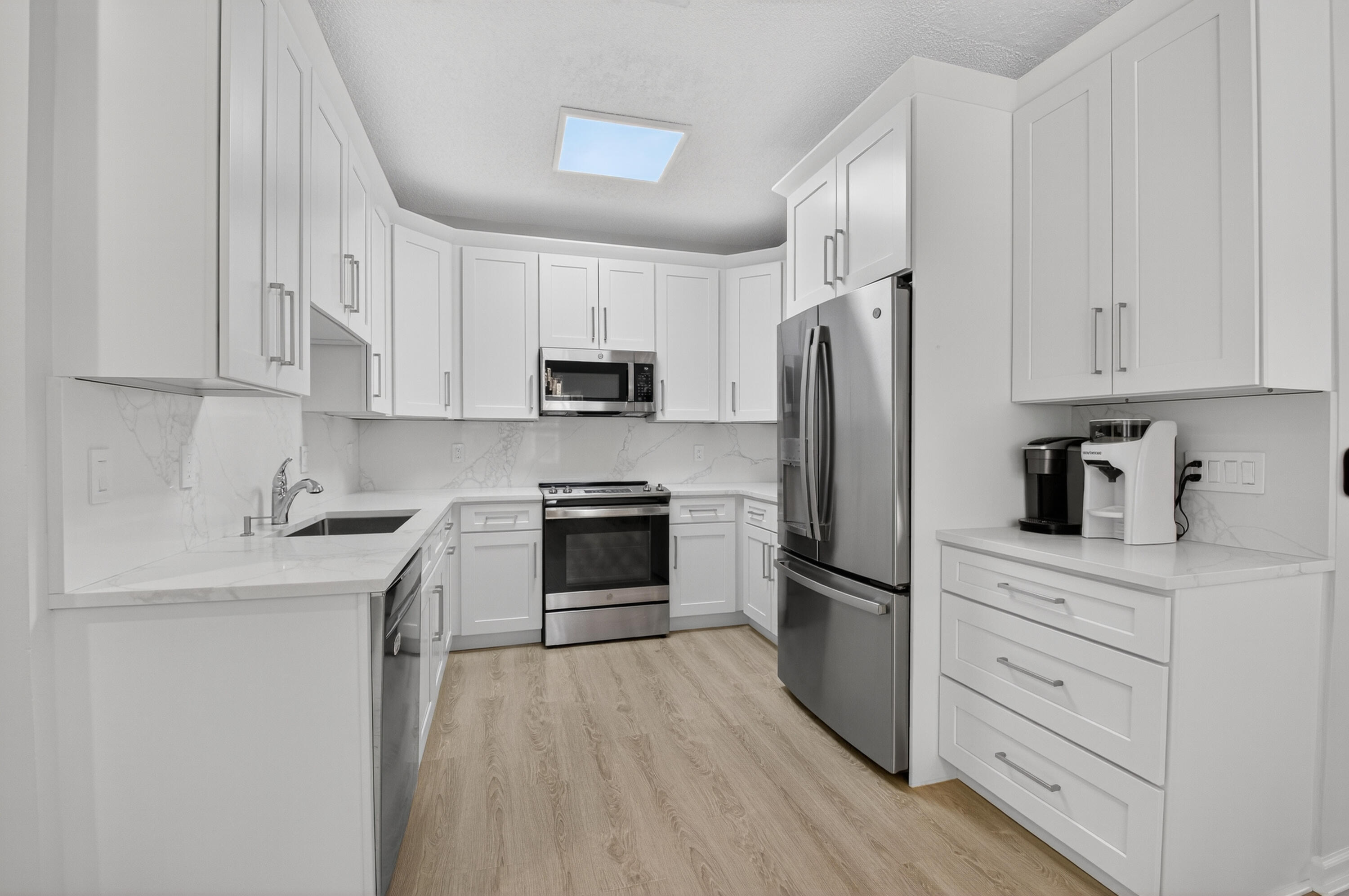 21048 Vía Eden Boca Raton, FL 33433 - Photo 5 of 53 a kitchen with cabinets stainless steel appliances a sink and a counter space