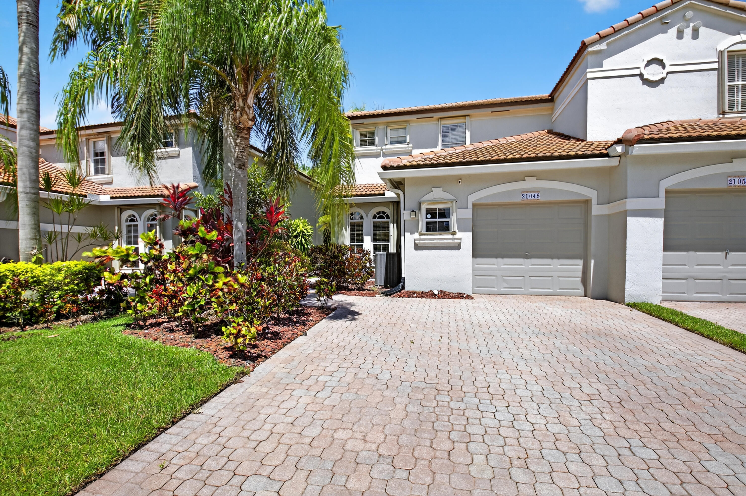 21048 Vía Eden Boca Raton, FL 33433 - Photo 52 of 53 a front view of a house with a garden