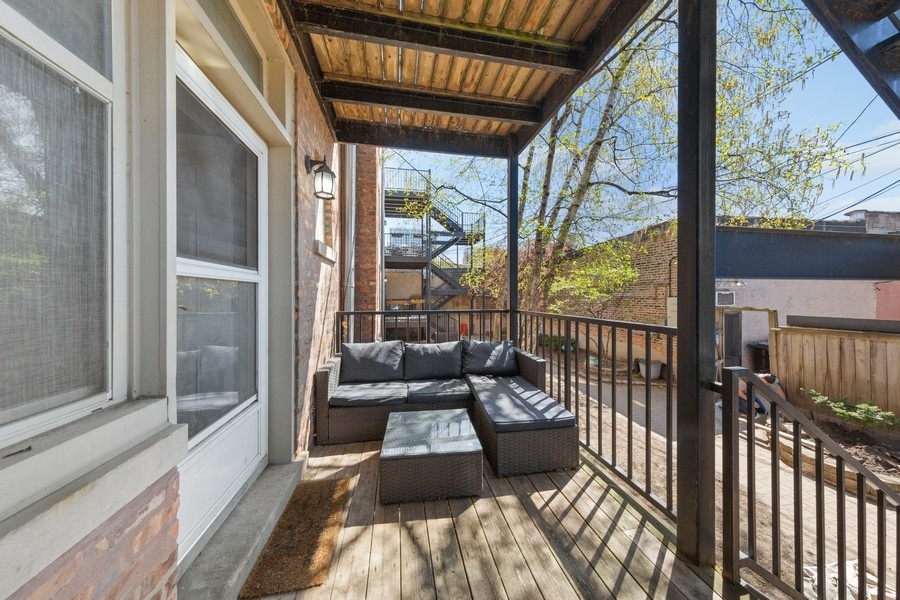 3942 North Clarendon Avenue, Unit 1N Chicago, IL 60613 - Photo 12 of 13 a balcony with furniture and floor to ceiling window