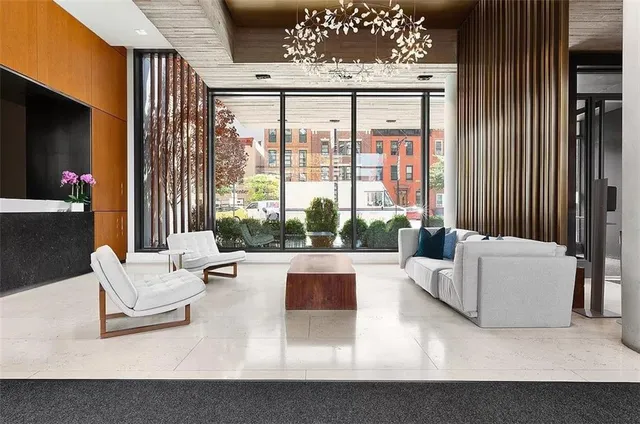 a living room with furniture and large windows