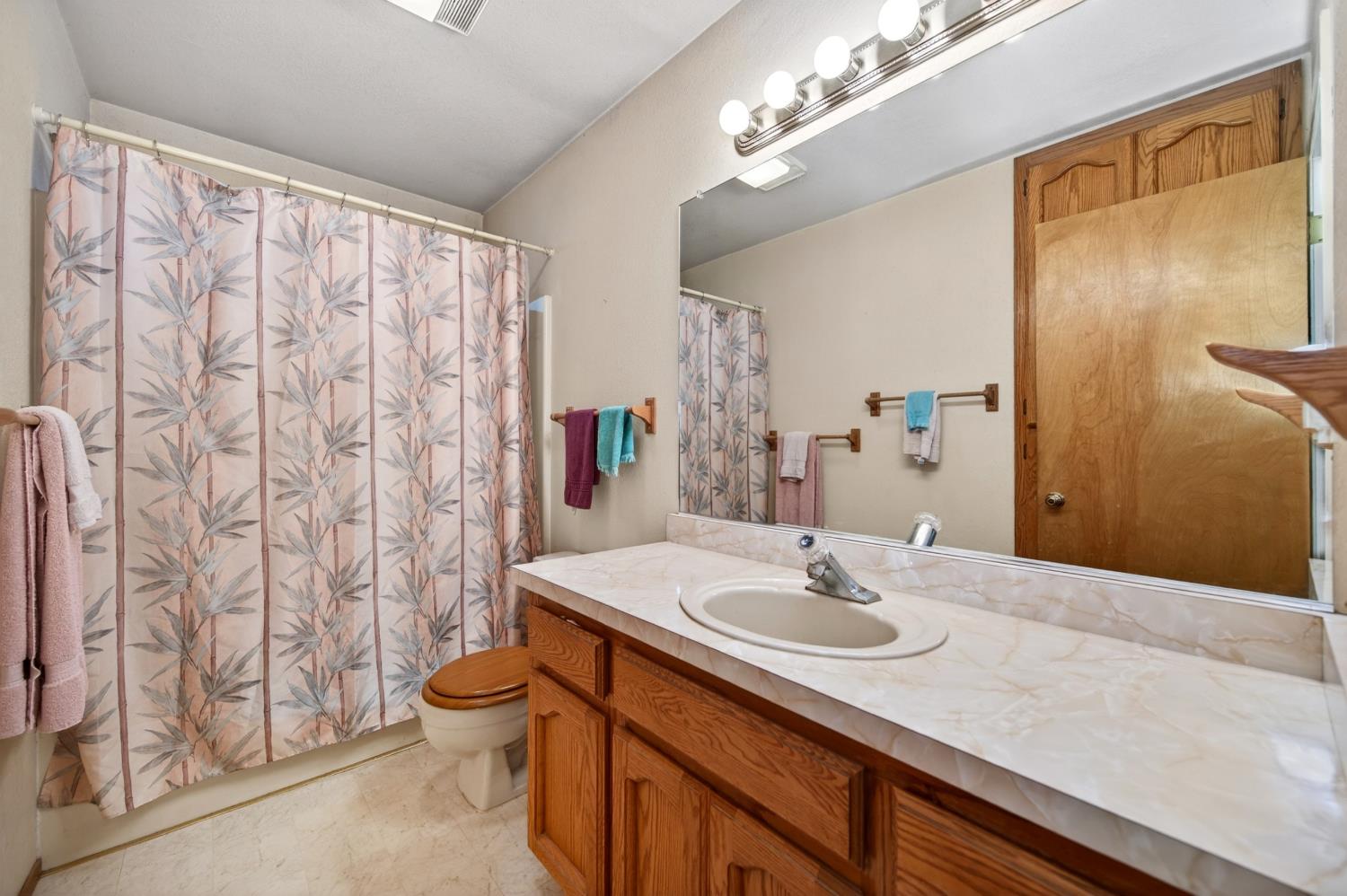 20191 Kit Court Volcano, CA 95689 - Photo 40 of 54 a bathroom with a granite countertop sink a toilet and a mirror