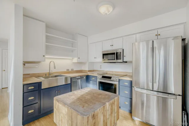 a bathroom with a toilet sink vanity and mirror