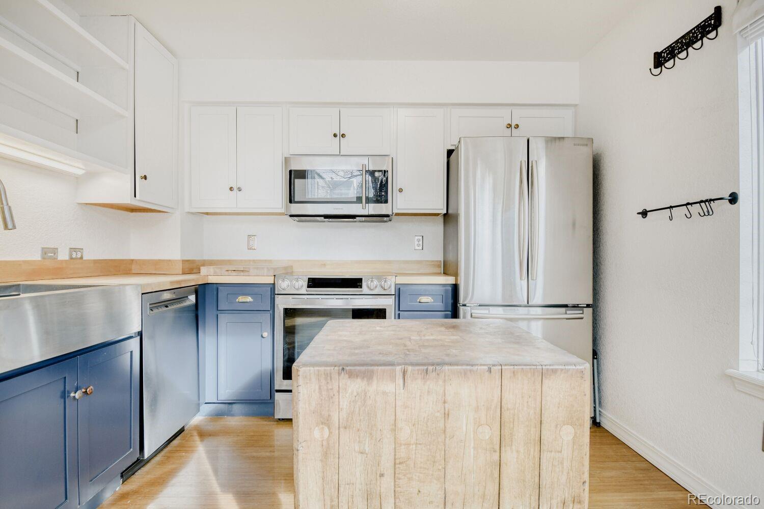5174 Buckingham Road Boulder, CO 80301 - Photo 14 of 33 a kitchen with kitchen island a counter top space stainless steel appliances and cabinets