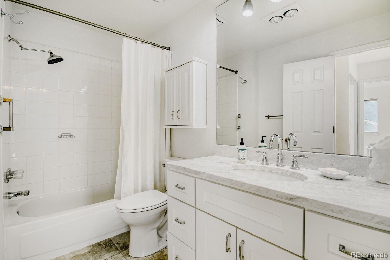 5174 Buckingham Road Boulder, CO 80301 - Photo 23 of 33 a bathroom with a granite countertop sink a toilet and shower