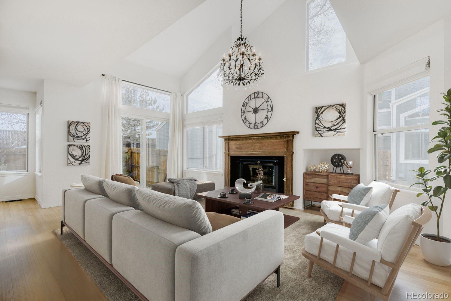 5174 Buckingham Road Boulder, CO 80301 - Photo 4 of 33 a living room with furniture a fireplace and a large mirror