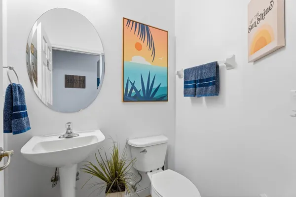 a bathroom with a toilet sink and mirror
