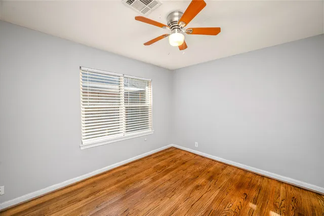 wooden floor in a room next to a window