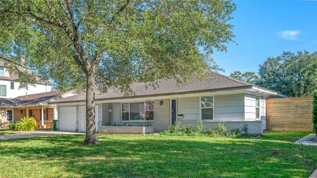 a front view of a house with a yard and porch