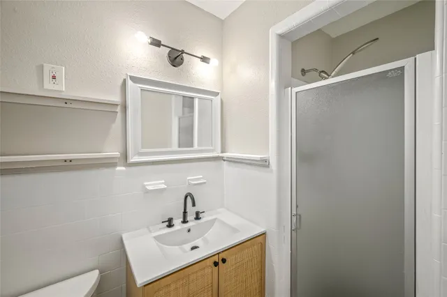 a bathroom with a sink vanity and mirror