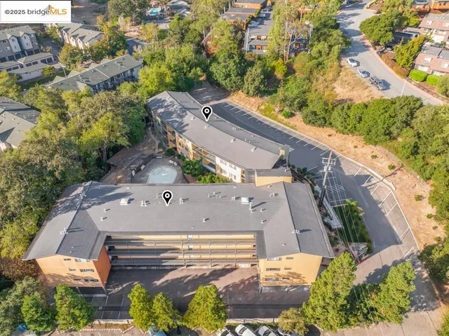 an aerial view of a house with a yard