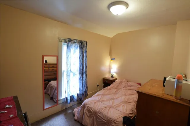 a bedroom with a bed and a mirror